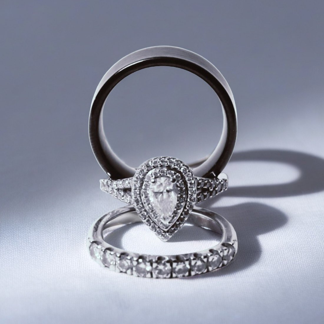 A pair of rings standing upright on a bare tabletop, as a listing shot