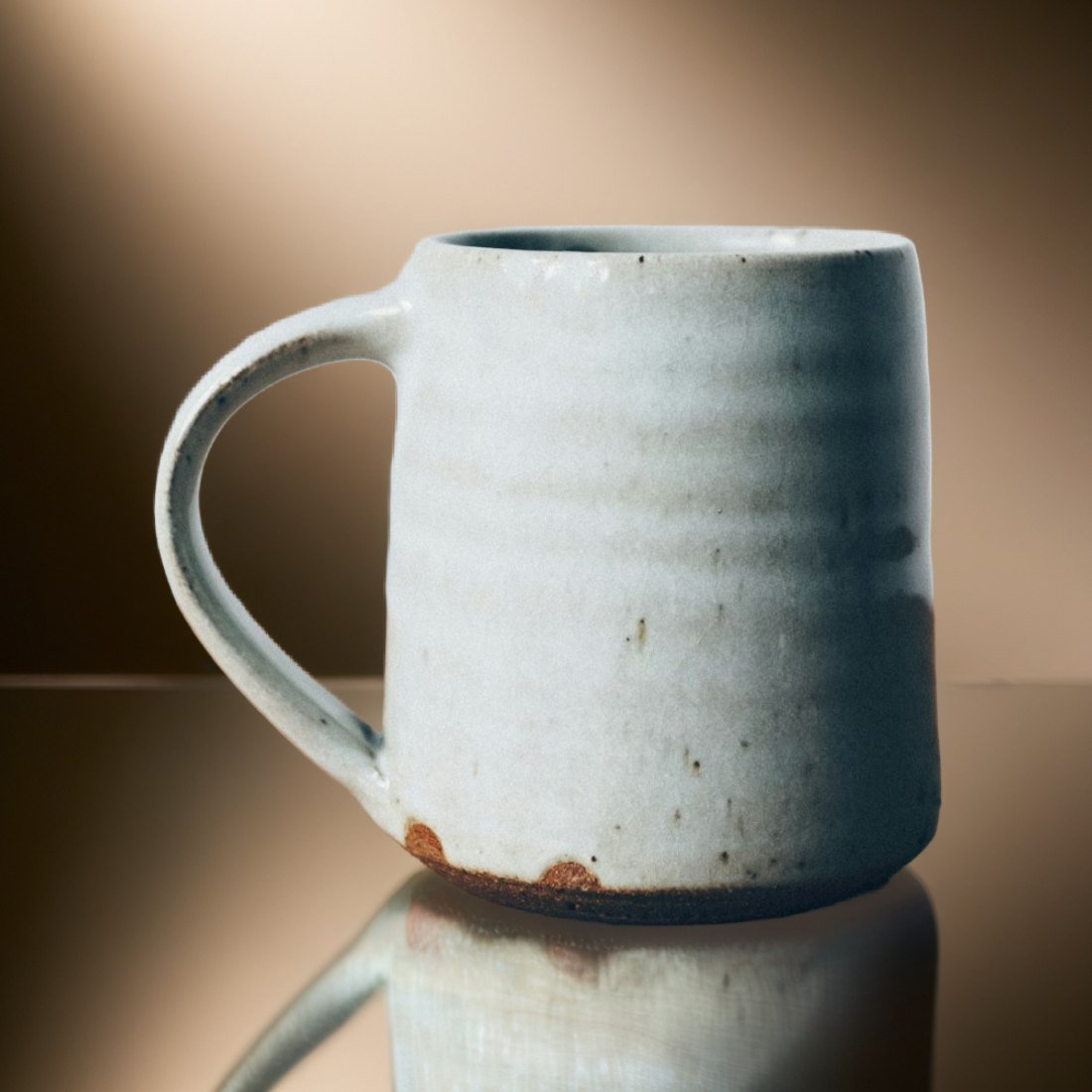 A white stoneware mug with a raw clay foot, as a listing shot